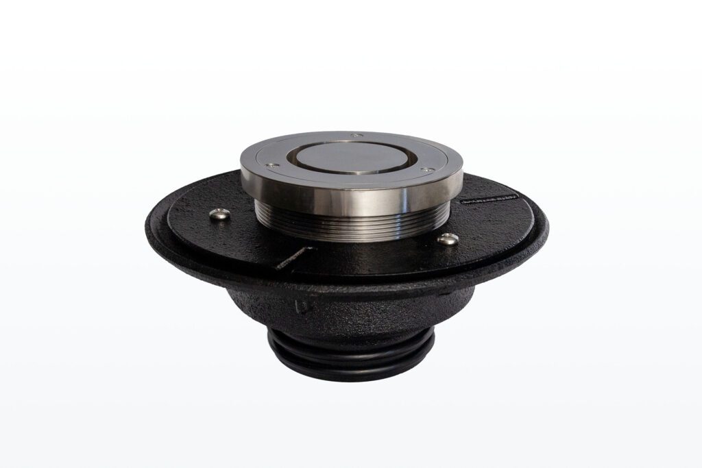 A metal and black industrial floor drain with a threaded top and circular base, designed for installation in flooring. The background is plain white.